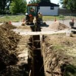 men working on a water line excavation