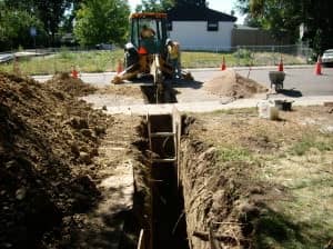 men working on a water line excavation