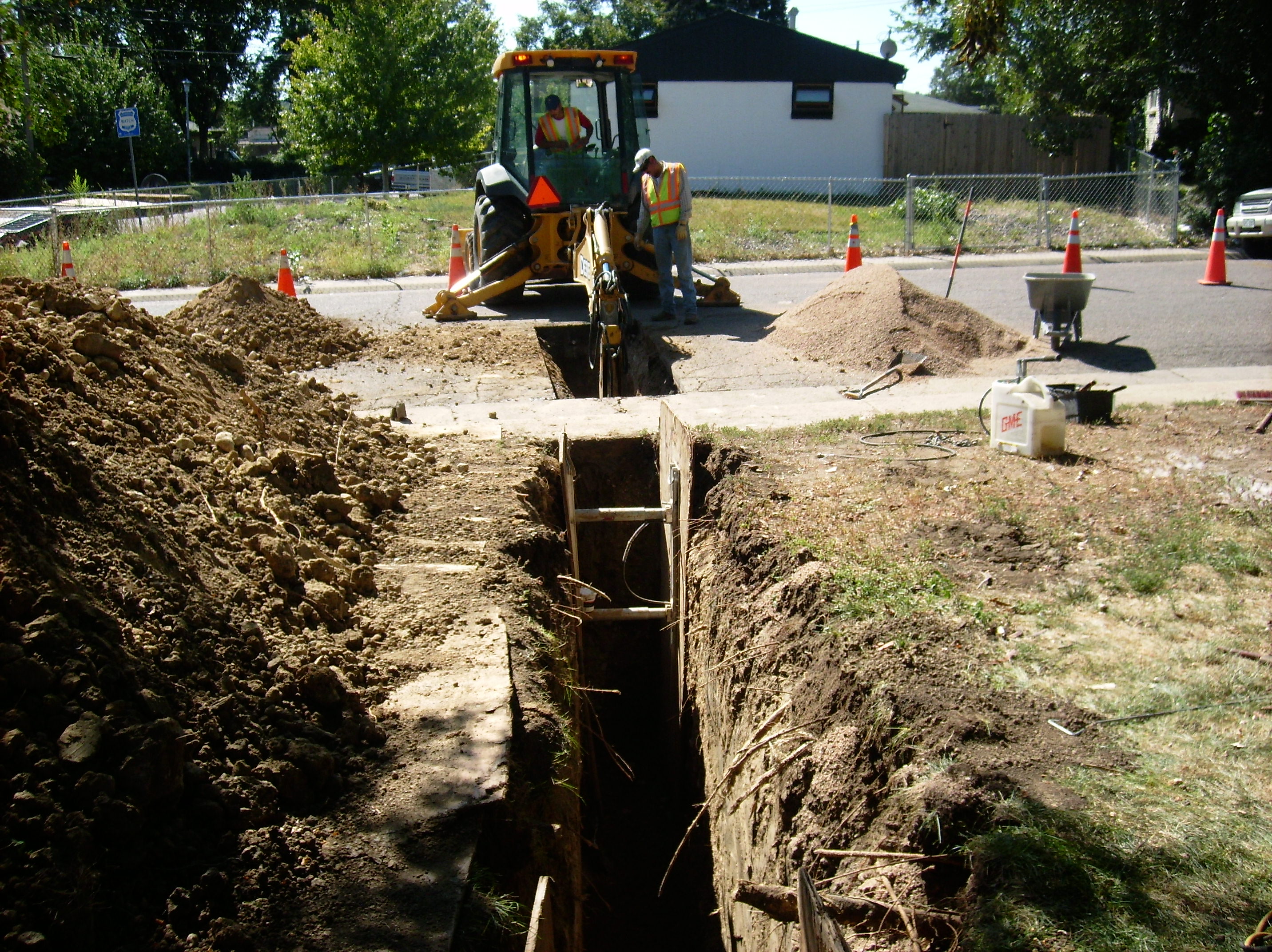 men working on a water line excavation