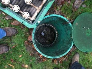 man repairing a septic tank