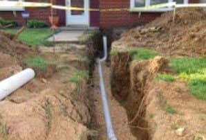 A littleton residential sewer line replacement that has the yard dug up and new pipes being installed.
