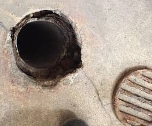 An outdoor drain in concrete.