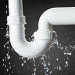 White PVC pipe with U joint leaking from connections