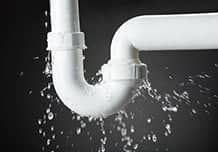 White PVC pipe with U joint leaking from connections