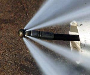 A hydro jet drain cleaning tool with high pressure water stream.