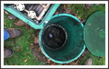 man repairing a septic tank