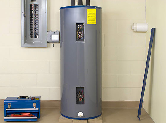 New 40- or 50-gallon hot water heater installed; blue toolbox on the floor