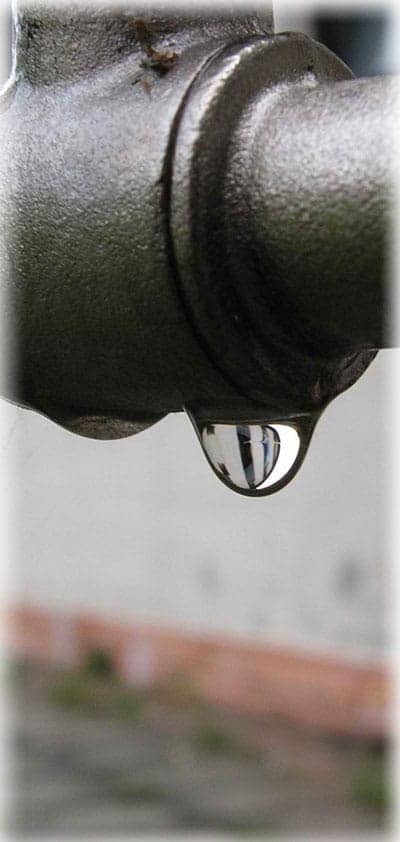 Water running from a stainless steel faucet