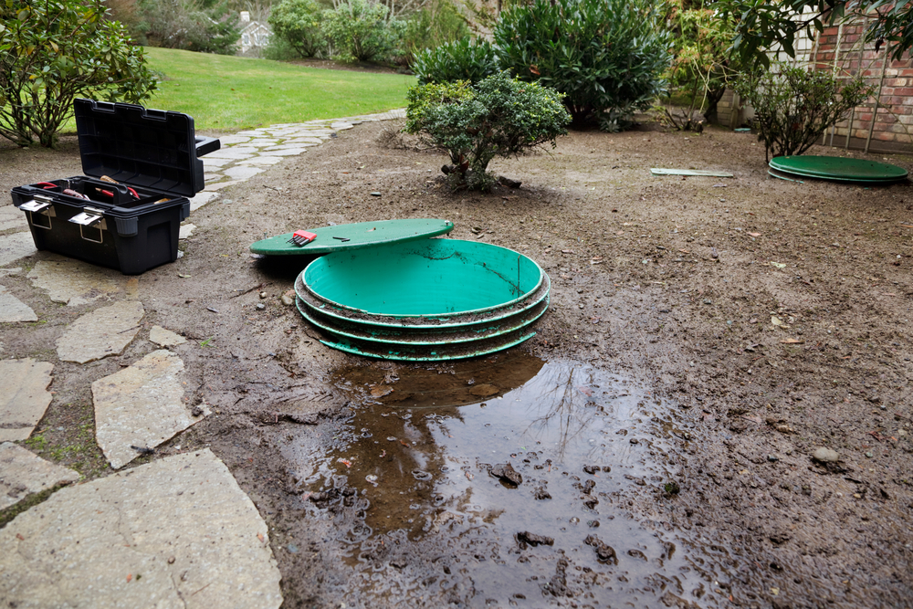 A leaking septic tank with the lid removed for repairs.