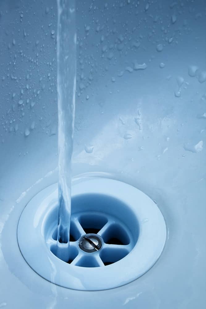 A stream of water flows easily down a drain that has just been cleaned