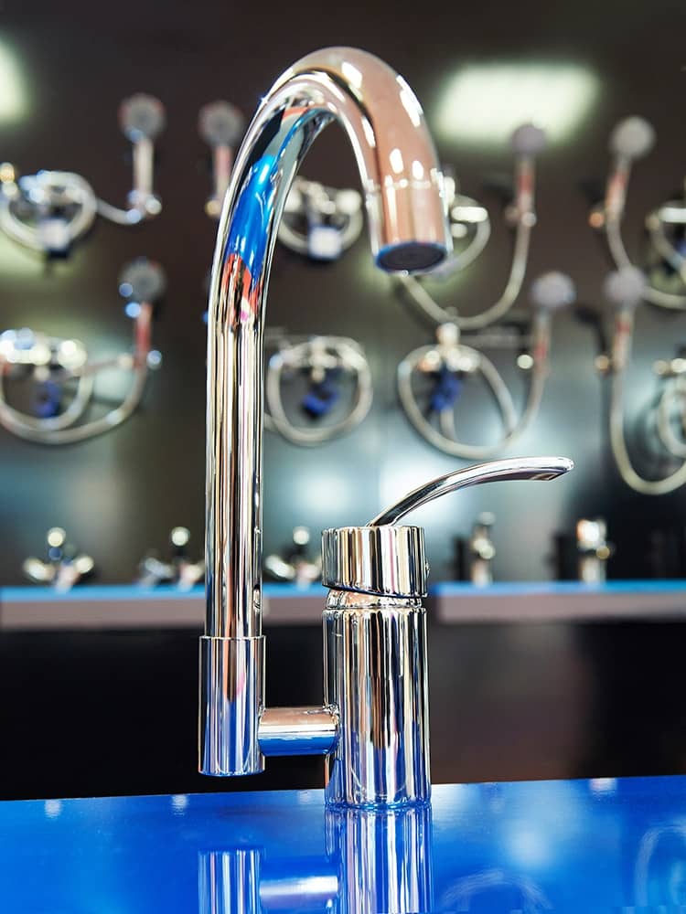 A display of a new chrome kitchen plumbing fixture to be installed
