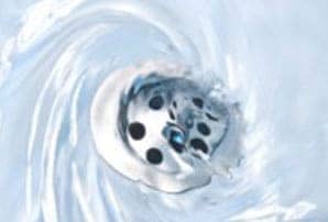 Water swirling down a clean tub drain