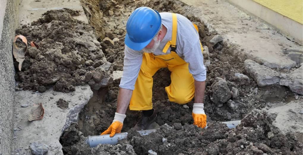 Home renovation, plumber fixing sewerage pipe