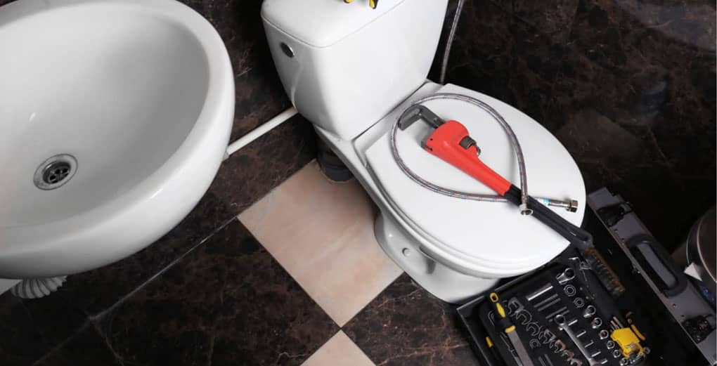 Plumber's tools on toilet