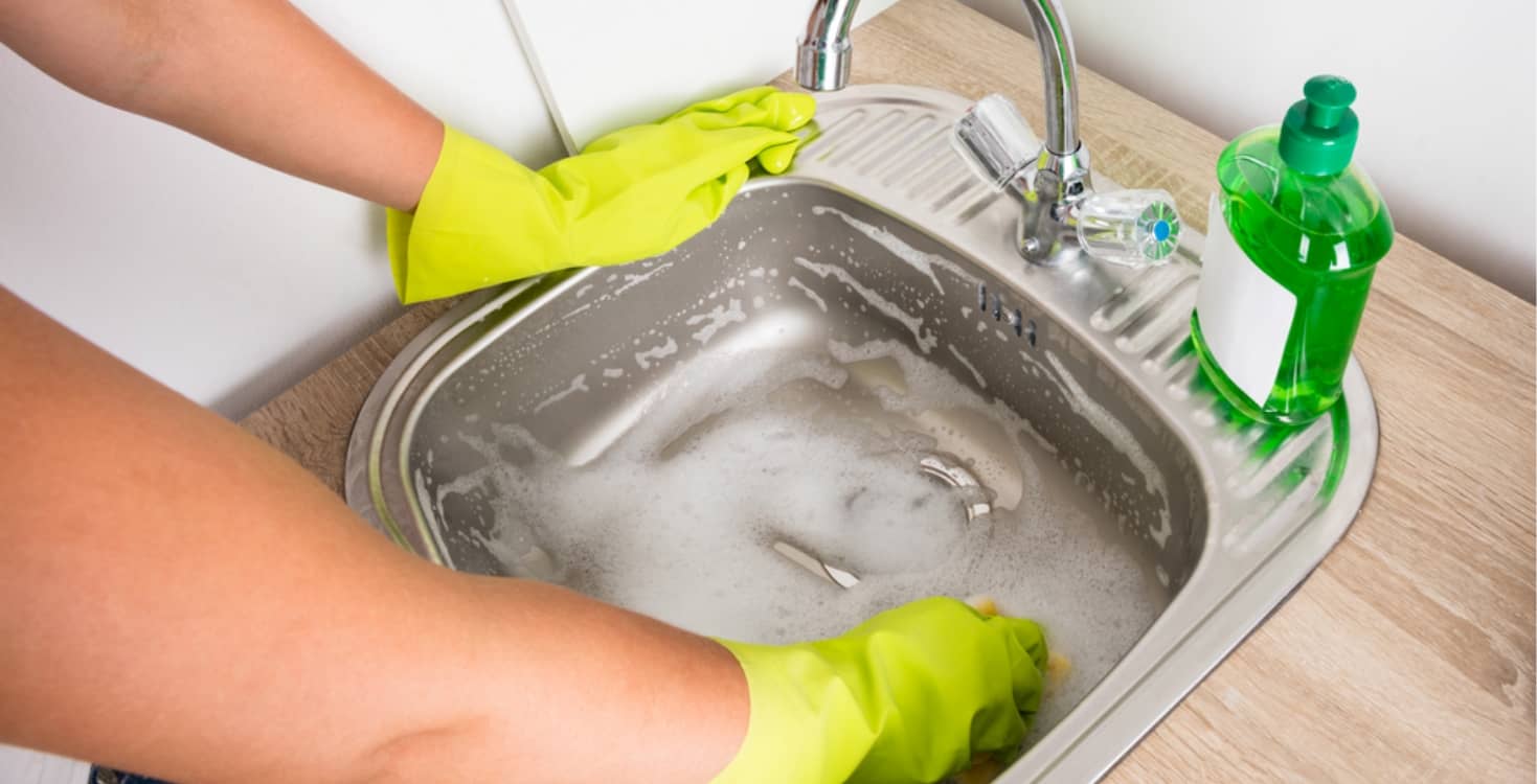 Woman Cleaning Sink